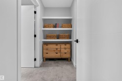 Built-in shelving with three open shelves and a wood-finish six-drawer dresser - 