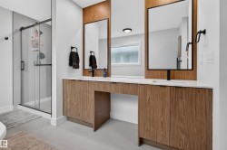 Dual wood-finish vanities with integrated sinks and quartz countertops - 