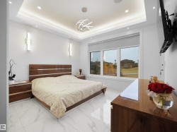 Tray ceiling with recessed lighting, integrated wall sconces, large windows, and a contemporary pendant light fixture - 