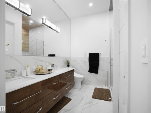 Dual vanity with wood-finish cabinetry and rectangular undermount sinks - 4809 Woolsey Lane Nw, Edmonton, AB 