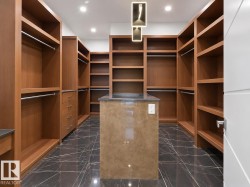Custom closet system with extensive shelving and hanging rods - 