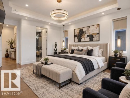 Tray ceiling with recessed lighting, central chandelier, wood-finish flooring, and double-door entry - 4809 Woolsey Lane Nw, Edmonton, AB 