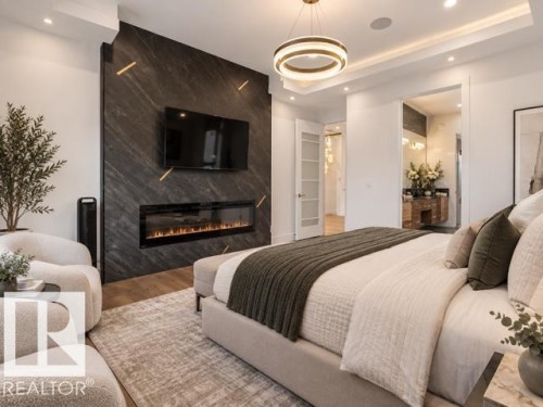 Feature wall with a linear electric fireplace, wood-finish flooring, recessed lighting, and a contemporary chandelier - 4809 Woolsey Lane Nw, Edmonton, AB 