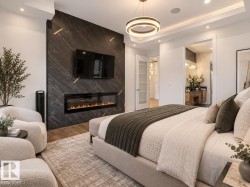 Feature wall with dark stone-finish paneling, linear electric fireplace, and recessed television - 
