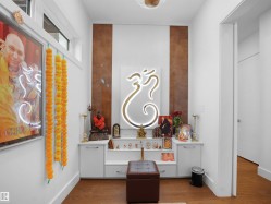 Built-in display cabinetry with a white finish, wood-finish flooring, and transom windows - 