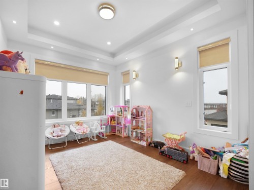 Recessed lighting, tray ceiling, hard surface flooring, multiple windows, and wall sconces - 4809 Woolsey Lane Nw, Edmonton, AB 