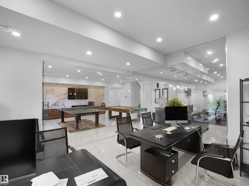 Expansive interior space featuring a large desk area, glass wall partitions, recessed lighting, and polished floor tiles - 4809 Woolsey Lane Nw, Edmonton, AB 