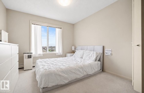 Wall-to-wall carpeting and a window with white trim - #419 5515 7 Av Sw, Edmonton, AB 