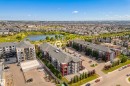 Expansive residential complex featuring multiple buildings, surface parking, and a prominent nearby pond - #419 5515 7 Av Sw, Edmonton, AB 