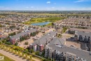 Multi-story residential buildings featuring balconies, surface parking, and landscaped grounds - #419 5515 7 Av Sw, Edmonton, AB 