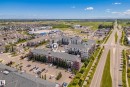 Multi-story residential buildings featuring balconies and surface parking - #419 5515 7 Av Sw, Edmonton, AB 