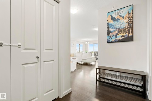 Rich wood-finish flooring throughout, white interior walls, and recessed lighting - #419 5515 7 Av Sw, Edmonton, AB 