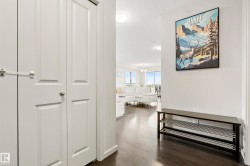Rich wood-finish flooring throughout, white interior walls, and recessed lighting - 