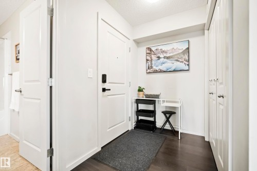 Dark wood-finish flooring with white walls and trim - #419 5515 7 Av Sw, Edmonton, AB 