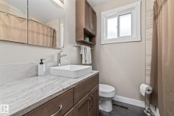 White rectangular vessel sink with a chrome faucet, set on a light-toned countertop - 