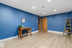 Spacious room with vibrant periwinkle walls and crisp white ceiling - 