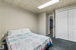 Carpeted flooring, white paneled wall, built-in wall shelving, and a window with blinds - 