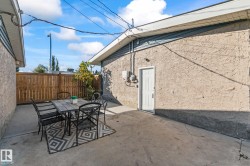 Expansive backyard with mature shade trees and lush, level lawn bordered by wood-finish fencing - 