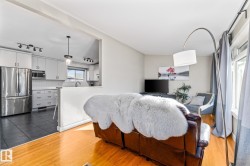Hardwood flooring throughout, neutral wall tones, and an open entryway - 