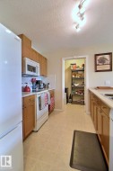 Kitchen featuring wood-finish cabinetry, a freestanding range, and a built-in microwave - 