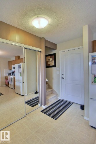 Tile flooring with a flush-mount ceiling light - #421 592 Hooke Rd Nw, Edmonton, AB 