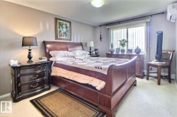 Wall-mounted split system, window with vertical blinds, and light-toned carpeting - 