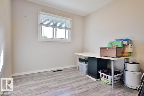 Neutral-toned walls complement wood-finish flooring - 13312 123A Street Nw, Edmonton, AB 