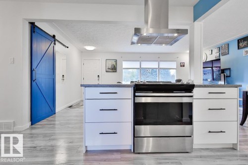 Stainless steel range with coordinating ventilation hood - 13312 123A Street Nw, Edmonton, AB 