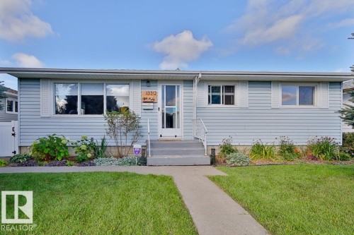 Light blue siding exterior with white trim windows and a white front door - 13312 123A Street Nw, Edmonton, AB 