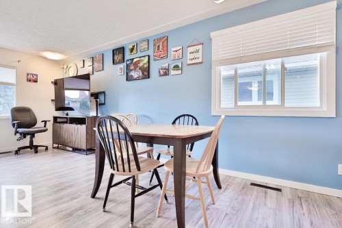 Wood-finish flooring, recessed lighting, and a window with white blinds - 13312 123A Street Nw, Edmonton, AB 