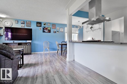 Open-concept living area with wood-finish flooring - 13312 123A Street Nw, Edmonton, AB 
