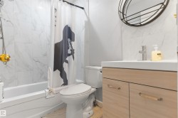 White tile shower surround, integrated bathtub, and a modern vanity with a white countertop - 