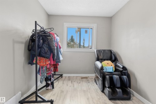 Wood-finish flooring, white trim, and a window with white casing - 4824 13 Avenue Nw, Edmonton, AB 
