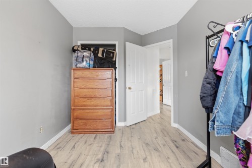 Wood-finish flooring with light gray walls and white trim - 4824 13 Avenue Nw, Edmonton, AB 