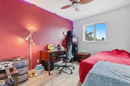 Wood-finish flooring with a ceiling fan and a window - 4824 13 Avenue Nw, Edmonton, AB 