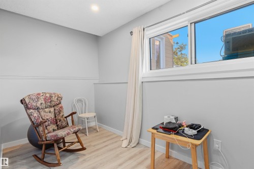 Recessed lighting, wood-finish flooring, and a large window with white trim - 4824 13 Avenue Nw, Edmonton, AB 