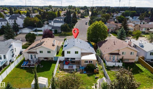 Two-story residence with a light-colored exterior and a brown roof - 4824 13 Avenue Nw, Edmonton, AB 