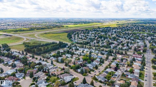Aerial perspective of a residential neighborhood with established homes, mature landscaping, and interconnected roadways - 4824 13 Avenue Nw, Edmonton, AB 