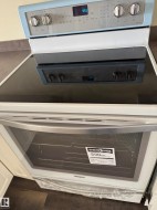 New electric range with a smooth cooktop surface and digital controls - 