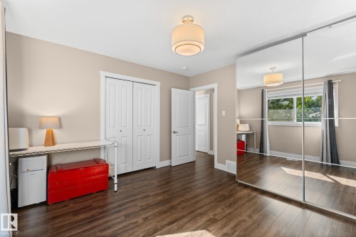Laminate flooring, neutral wall paint, a large window letting in alot of natural light, a large closet, and a PAX wardrobe system included. - 6108 102 Avenue Nw, Edmonton, AB 
