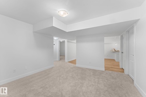 Neutral paint colors with ceiling mounted lighting, plush carpeting, and wood-finish flooring - 6108 102 Avenue Nw, Edmonton, AB 