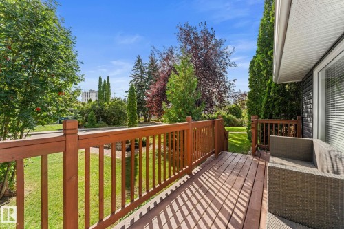 Wood-finish deck with matching railings - 6108 102 Avenue Nw, Edmonton, AB 