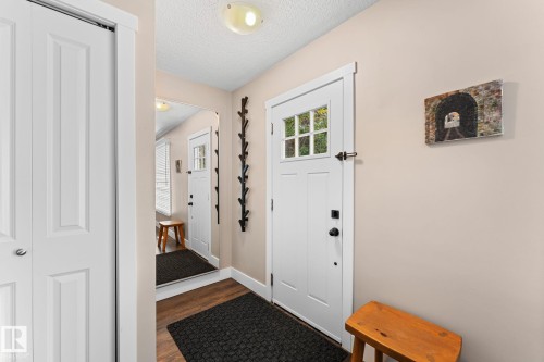 Laminate flooring, white paneled doors, and ceiling-mounted light fixture - 6108 102 Avenue Nw, Edmonton, AB 