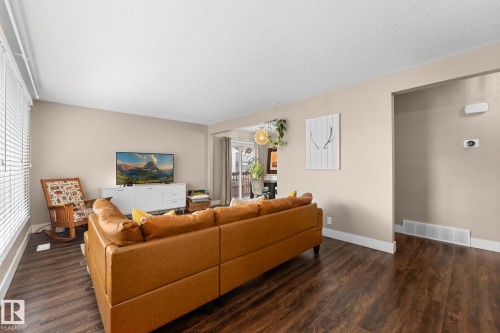 Living area with laminate flooring and neutral wall tones - 6108 102 Avenue Nw, Edmonton, AB 