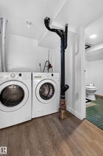Laundry area featuring wood-finish flooring and white walls - 6807 112A Street Nw, Edmonton, AB 