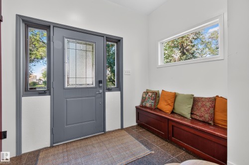 Entryway featuring a paneled door with decorative glass, side lites, and a transom window - 6807 112A Street Nw, Edmonton, AB 