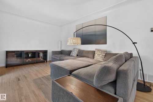 Light wood-finish flooring with white painted walls - 6807 112A Street Nw, Edmonton, AB 