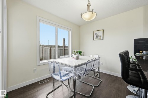 Recessed lighting, wood-finish flooring, white trim, and a window with a white frame - 941 Ebbers Crescent Nw, Edmonton, AB 