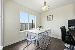 Recessed lighting, wood-finish flooring, white trim, and a window with a white frame - 