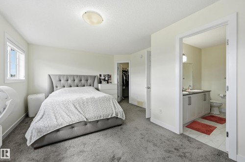Expansive room with neutral walls, light gray carpeting, and a window providing natural light - 941 Ebbers Crescent Nw, Edmonton, AB 